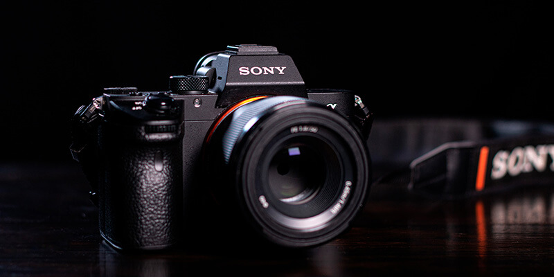 4K video_mirrorless Two editors review a timeline over three monitors attached to a mac studio