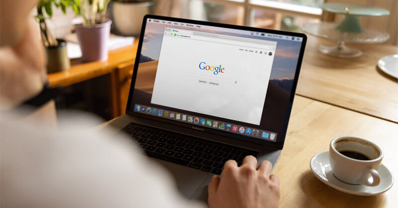 MASV-How-to-Upload-Faster-Browser-Google A man uses a browser window to open Google on his laptop