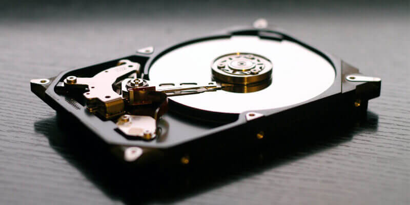 transfer-raw-footage-disk-drive Close up of the inside of a hard disk drive used to store raw files and video footage